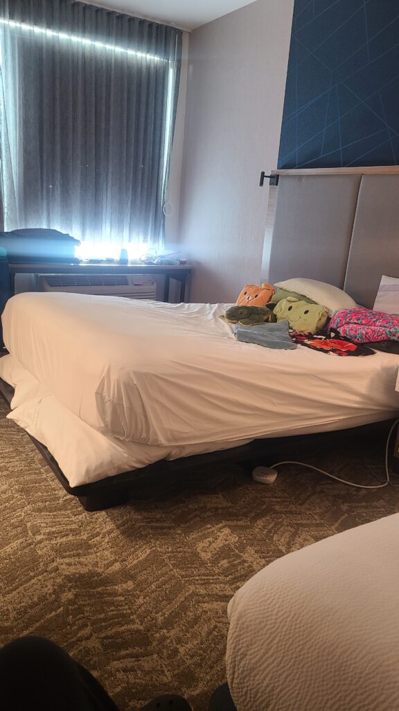 picture of hotel mattress with pillows under the head to raise up and pillows and blankets and heating pads adapted for sleeping