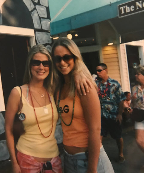 Ali able-bodied standing next to best friend in Key West with long blonde hair, orange tank top and miniskirt
